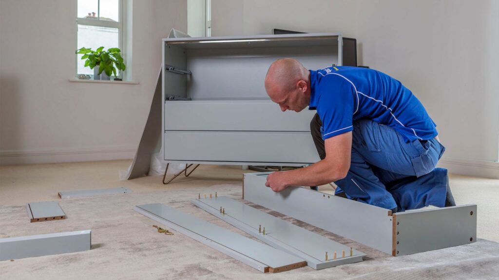 Handyman assembling flatpack of drawers