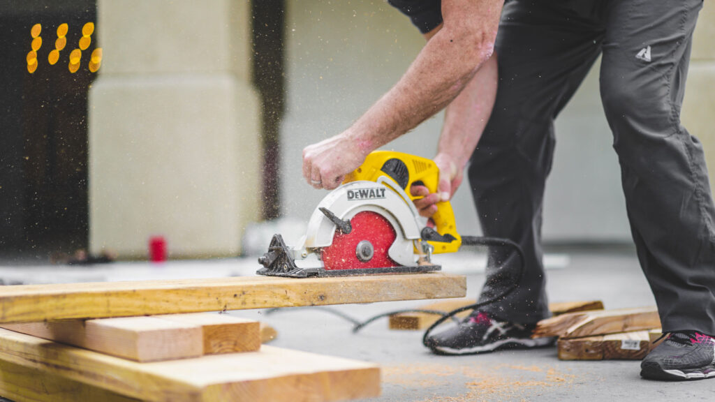 Handyman cutting timber with skill saw